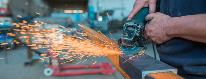 An image of a fabricator at Channel Manufacturing creating foodservice equipment.