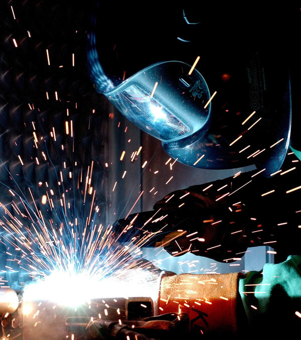 An image of a welder at work on foodservice equipment at Channel Manufacturing