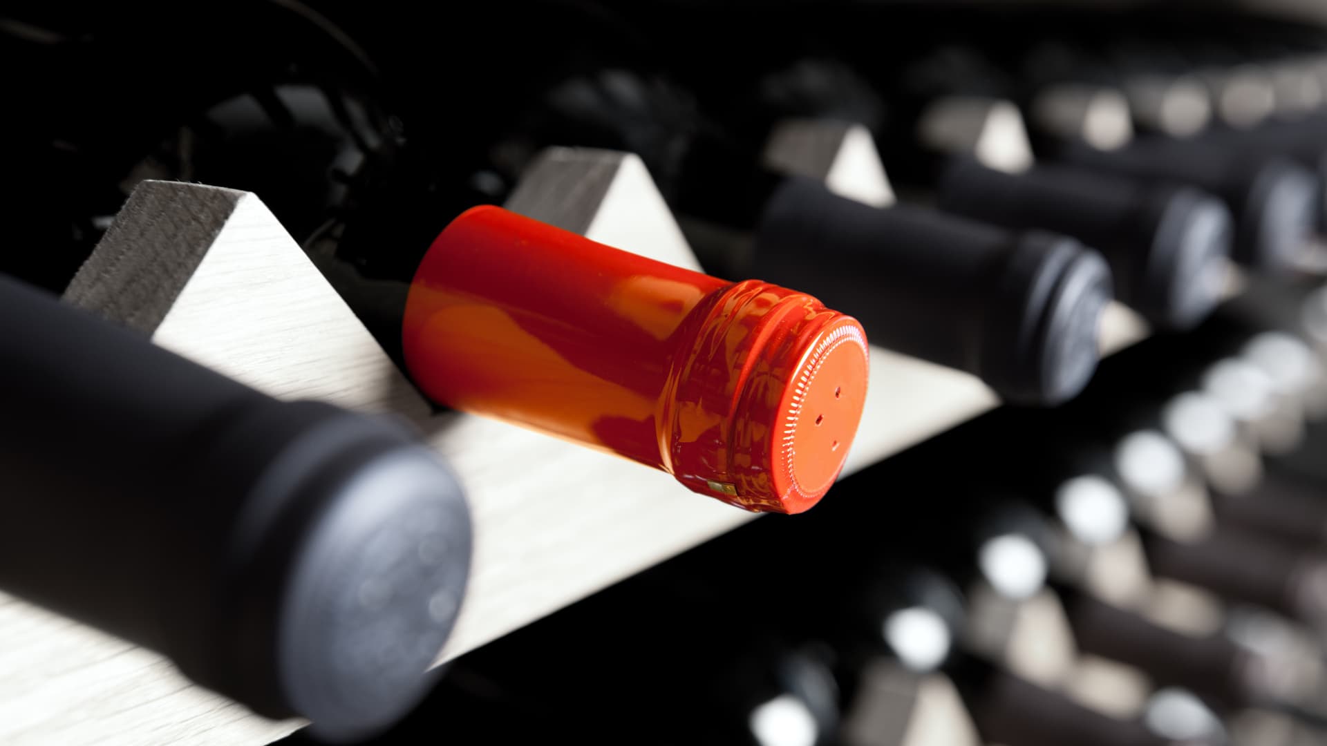 Ready for your favorite wine? An image of wine bottles on a rack in a restaurant.