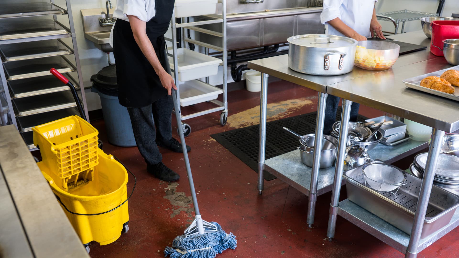 Commercial Foodservice in Action An image of team members cleaning and working in a commercial kitchen.