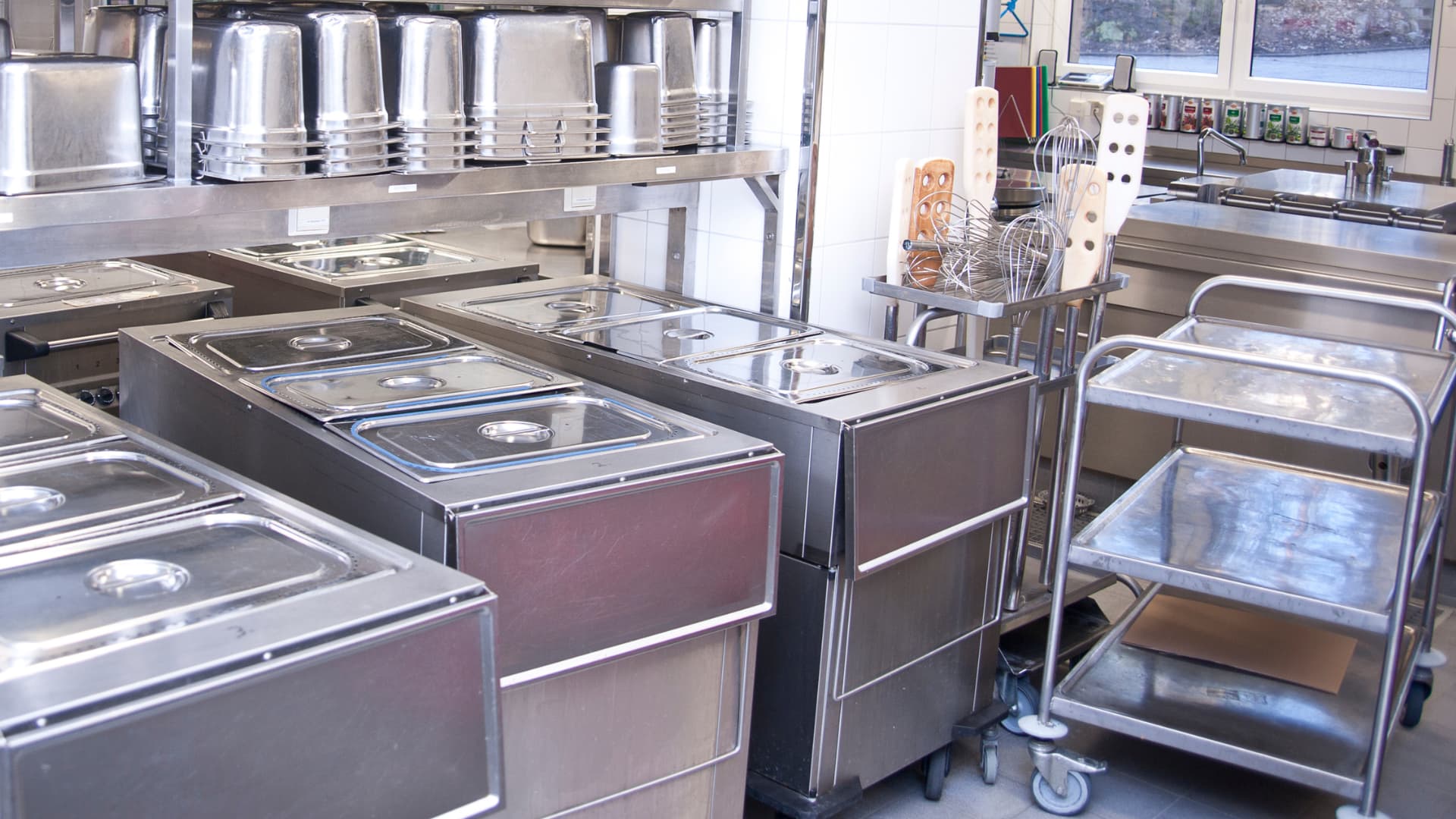 Utility Carts for your Restaurant An image of a utility cart in action in a commercial kitchen space.